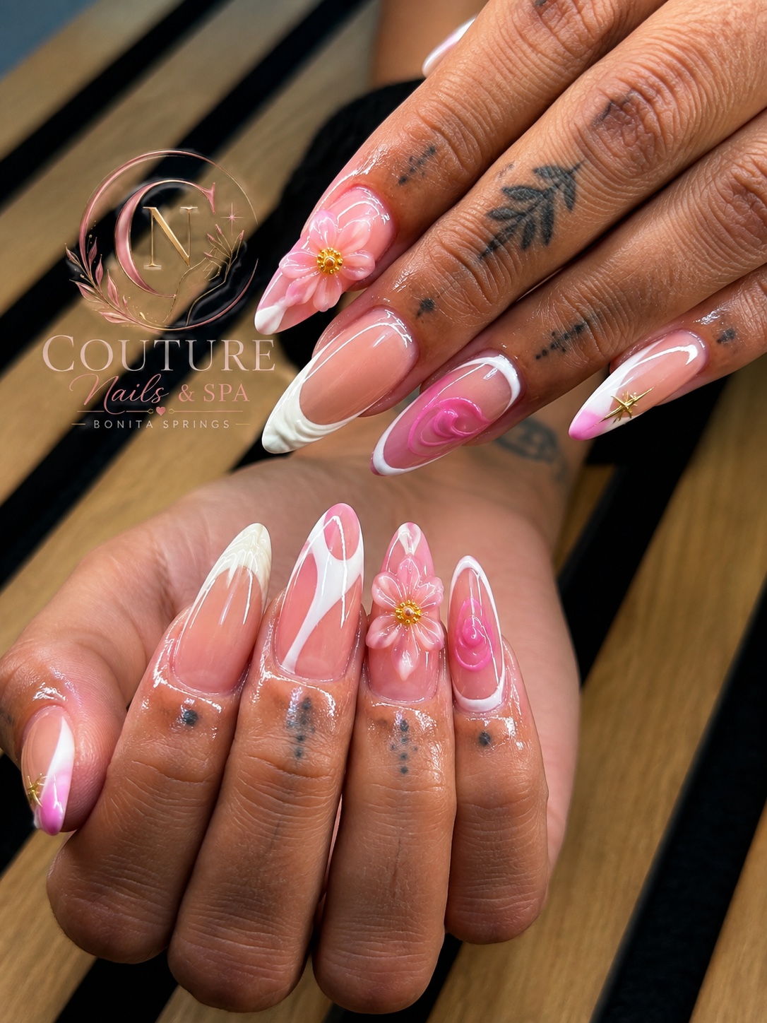 Pink and white floral nail art by Couture Nails & Spa